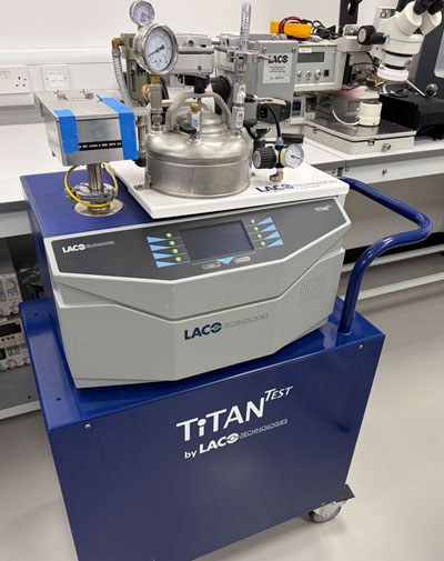 Titan helium leak detector and helium bombing system for MIL-STD-883 fine leak hermeticity testing at Reltronix